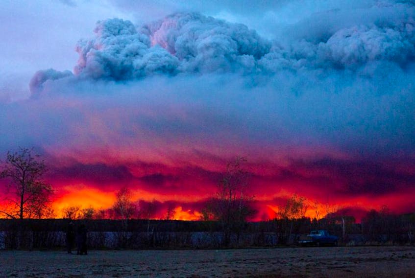 A wildfire moves towards the town of Anzac from Fort McMurray, Alberta., on Wednesday May 4, 2016. Alberta declared a state of emergency Wednesday as crews frantically held back wind-whipped wildfires. Unseasonably hot temperatures combined with dry conditions have transformed the boreal forest in much of Alberta into a tinder box.