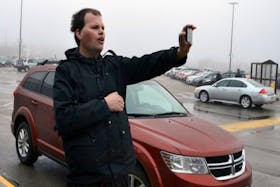 Amateur weatherman Frankie MacDonald issues a weather warning about area fog on his mobile device in front of the Mayflower Mall in Sydney. The Whitney Pier resident's videos have received more than 10 million views.