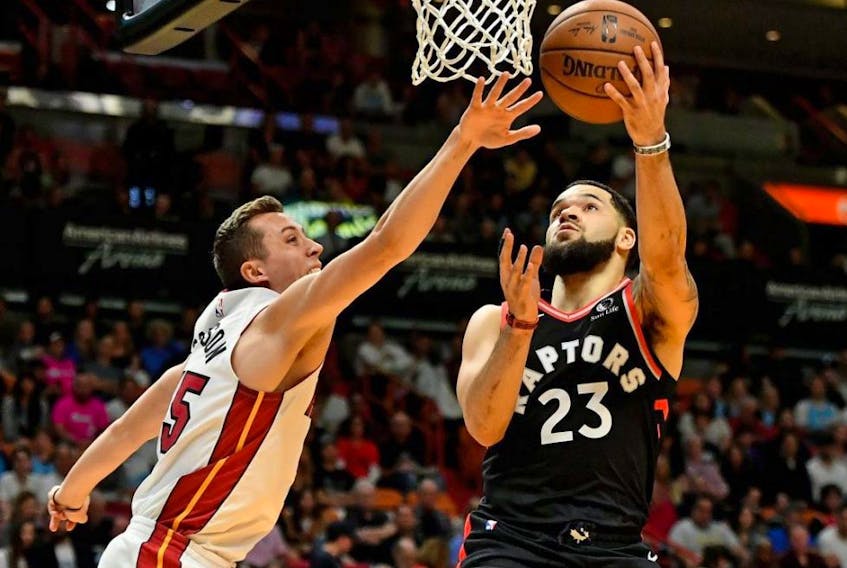Raptors guard Fred VanVleet (right) shoots around Heat forward Duncan Robinson (left) during the first half NBA action at American Airlines Arena in Miami, Jan. 2, 2020.