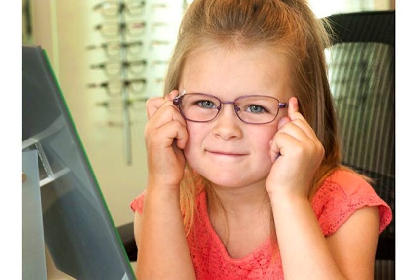 <p>Five-year-old Brynlie Desroches tries on her new glasses. Kindergarten students in P.E.I. can get free eye exams and glasses through a program co-sponsored by government and private industry.</p>
