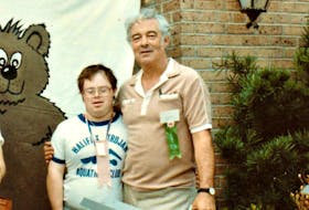 Honourable William (Bill) Malcolm MacEachern with his son Andrew in Baton Rouge, Louisiana, for the International Special Olympic Games (1983). Andrew took home the silver medal for Canada in 100 metres backstroke for swimming.