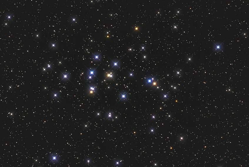 Praesepe, the "Beehive Cluster" (or M44 in the Messier Catalogue listing), is visible to the naked eye as a faint, nebulous patch of light. Try observing it with binoculars to get a full appreciation of the 1,000 or more blue-white stars in the cluster.