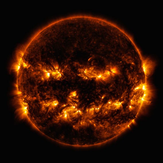 Active regions on the sun combined to look something like a jack-o-lantern’s face on Oct. 8, 2014. The active regions appear brighter because those are areas that emit more light and energy — markers of an intense and complex set of magnetic fields hovering in the sun’s atmosphere, the corona. This image blends together two sets of wavelengths at 171 and 193 angstroms, typically colorized in gold and yellow, as captured by the Solar Dynamics Observatory. - NASA/GSFC/SDO