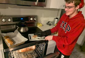 Zain Guthrie, 15, is learning to make all sorts of bread from scratch from his father. Scott Guthrie remembers learning to make bread with his grandmother and says it is time to pass the experience along to his son. 