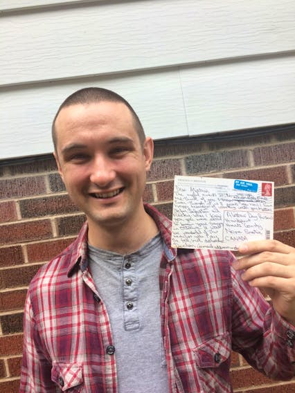 Alastair Day Parsons with a postcard he received in May. It was sent by a former Irish coworker he had not talked to since working at a restaurant in Montreal eight years ago.