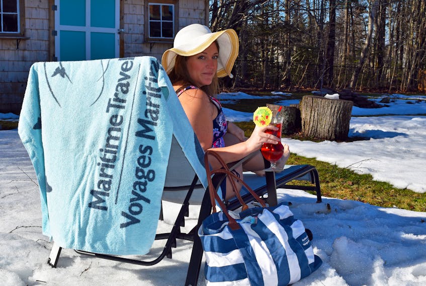 Larissa Newell, branch manager of Maritime Travel in Charlottetown, P.E.I., has been creating fun travel-inspired photographs to help people keep dreaming about travel, including a trip to the beach from her snowy backyard.