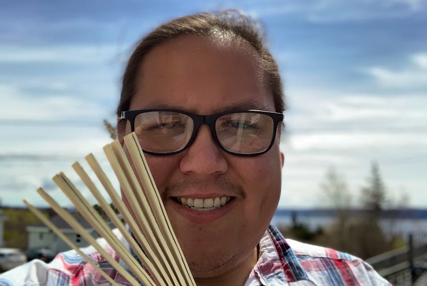 Michael Denny, a Mi’kmaq traditional musician, plays music that is traditional to Mi’kmaq culture, such as a wooden rattle called a Ji’kmaqn. 