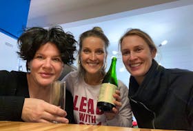 Emilie Chiasson toasts her new home with her friends Ally and Kate, who pitched in to finish off the final details of decorating and moving.