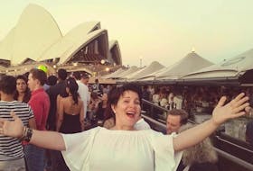 Emilie Chiasson sings outside the Sydney Opera House. With COVID-19 has grounded her in more ways than one - she's purchased her first home.