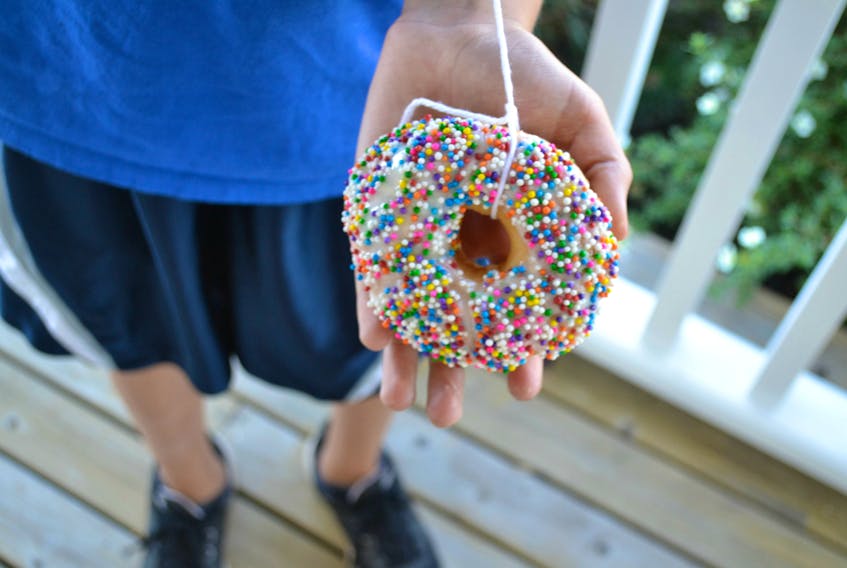 Engaging in easy food-based activities is an easy way for kids and parents to enjoy some summer fun. Consider eating donuts from a string, for example. 