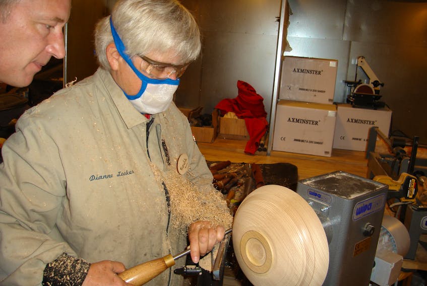 Dianne Looker turns the outside of a bowl using a lathe. Contributed photo/Dianne Looker 