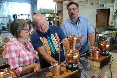 Wayne Johnson, centre, runs the GINstitute By the Sea experience at Steinhart Distillery in Arisaig, N.S. for owner Thomas Steinhart, right. Also pictured is participant Alison Stanton.