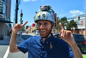 Local magician Vincenzo Ravina, sports a magic thought-projecting helmet that had previously rested atop the dome of the famous illusionist, Teller (of Penn & Teller fame). Chris Muise Photo
