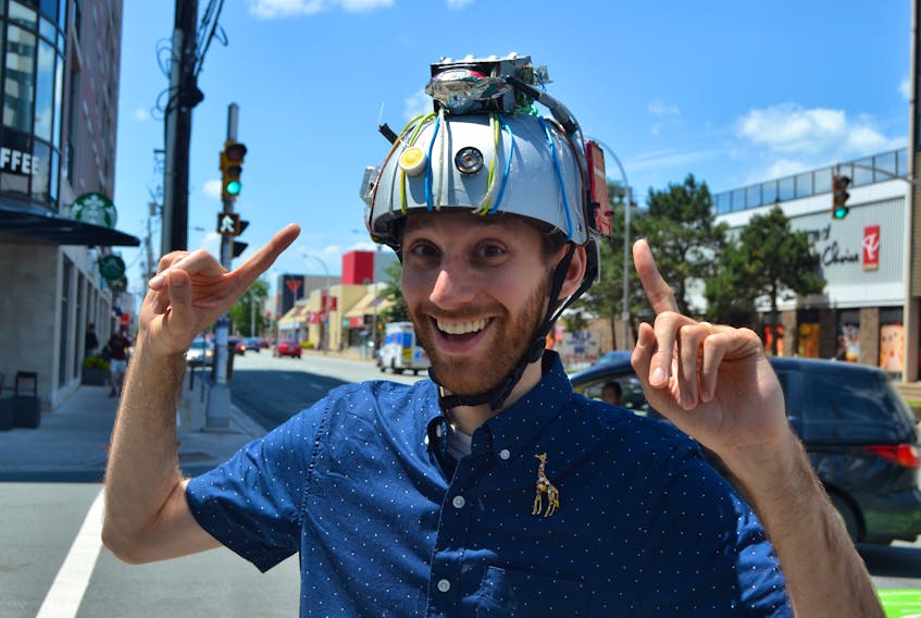 Local magician Vincenzo Ravina, sports a magic thought-projecting helmet that had previously rested atop the dome of the famous illusionist, Teller (of Penn & Teller fame). Chris Muise Photo