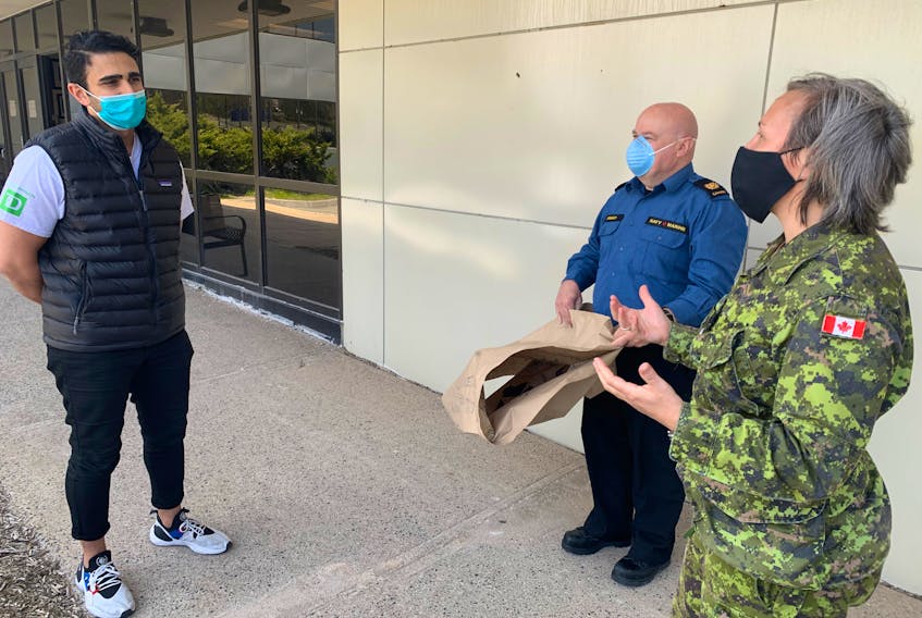 Halifax Lebanese Festival sponsorship director Anthony Saikali, left, delivers meals to officers at the naval hospital. Although the festival could not happen in its usual form this year, volunteers came together to show support for the community.