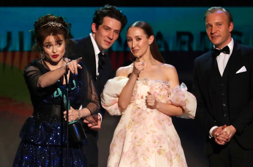 The Crown and Schitt's Creek led the contenders for the 2021 Golden Globes in TV. Here, cast members from The Crown, including Helena Bonham Carter, left, Josh O'Connor, Erin Doherty and Tobias Menzies accept the award for Outstanding Performance by an Ensemble in a Drama Series at the 26th Screen Actors Guild Awards in January 2020. - REUTERS/Mario Anzuoni