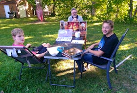 David Duke, centre, from Kentville, N.S., played Dungeons and Dragons in his youth, and now plays with his son Daniel, left, and his friend Daniel Comiskey.