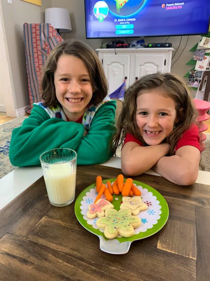 While Christmas won’t be the same this year, there will still be pockets of joy. Above, Heather Laura Clarke’s kids prepare to enjoy a holiday snack. Heather Laura Clarke Photo