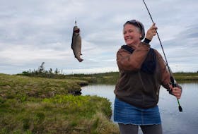 Mount Pearl, NL resident Jackie Pope, wearing her lucky skirt, hooks a keeper while her buddy walks back to the car for extra hooks. 