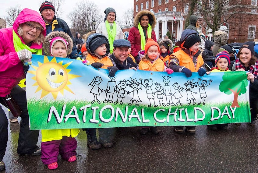 Families march through the streets for the National Child Day Parade held in Charlottetown, P.E.I. in 2019.