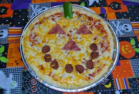 Make your family's pizza into a Halloween jack-o'-lantern for a fun Halloween dinner.