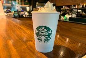 The Pumpkin Spice Latte itself, complete with a mountain of whipped cream. 