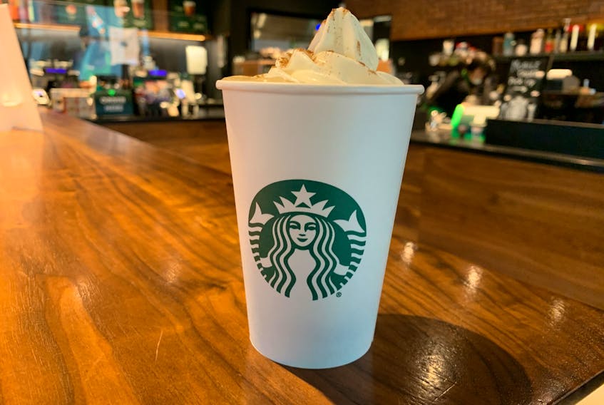 The Pumpkin Spice Latte itself, complete with a mountain of whipped cream. 