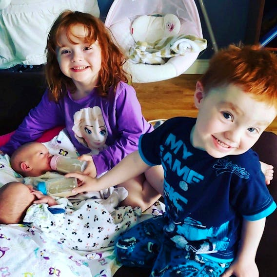 Twice as nice? Cassandra Murphy from Burin, N.L. has two sets of twins. Here, big sister Cavelle and her twin brother Xander take a closer look at their younger siblings – also twins – Hannah and Brody.
