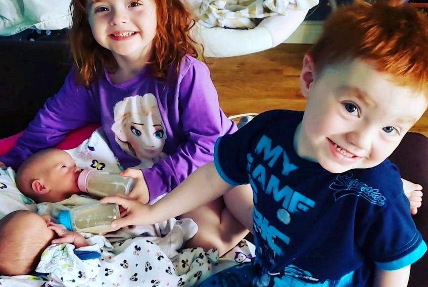 Twice as nice? Cassandra Murphy from Burin, N.L. has two sets of twins. Here, big sister Cavelle and her twin brother Xander take a closer look at their younger siblings – also twins – Hannah and Brody.