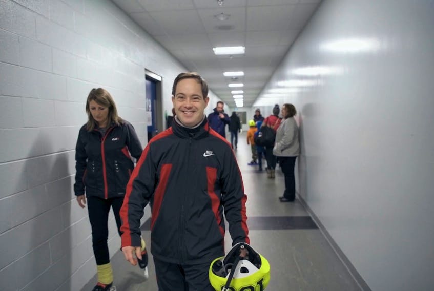 Sports enthusiast Philippe Caron always has a smile on his face before he glides onto the ice. - Courtesy of Sheila McGinn
