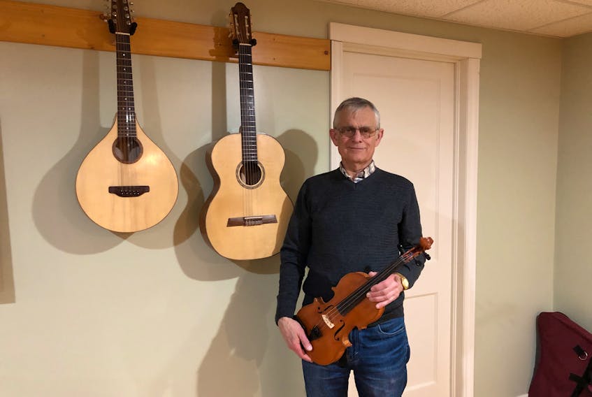 In his music room, you'll find hundreds of books related to music and woodworking, along with a keyboard, a harp, several violins and these three beautiful pieces - the first fiddle, cittern and guitar that Les Cooper handcrafted himself.