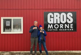 David Mosher and Laurie McMichael enjoy a cup of coffee outside their Gros Morne Coffee Roasters roasting facility in Deer Lake.