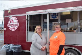 Tracy Higgins (right) and her mother, Cathy Higgins, in front of the Barnyard Grill food truck.