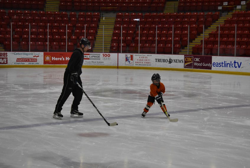 Ben Cumming having fun with daughter and hockey player Janelle, during a public skate at the Rath Eastlink Recreation Centre in the late fall. 
