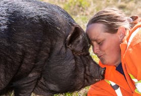 Dena Eales with her pot-bellied pig, Teaspoon. / SANDRA ST. CLAIR PHOTOGRAPHY