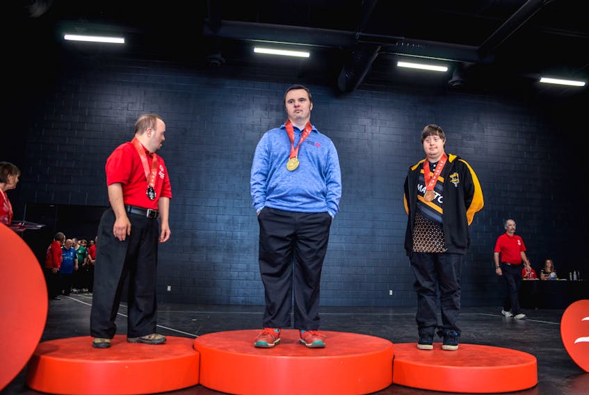 Geoff Burnes of Windsor recieves his medal on the podium at the Special Olympics national event. He won gold in the five-pin solo bowling event.