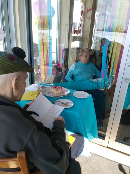 Residents of the Dr. John Gillis Memorial Lodge in Belfast, P.E.I. can enjoy a visit with their loved ones in a window dubbed 'Through the Looking Glass'. Family members can book a special Mother’s Day timeslot to visit loved ones. A recent birthday celebrated at the window included birthday cake for both the resident and family members.