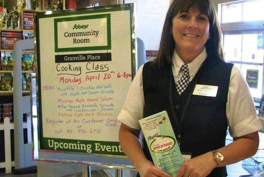 Sobeys manager Tammy MacPhee is participating in the “French: An Added Value” project for businesses in the Summerside area. She is holding one of the cards that customers can fill out to leave comments and&nbsp; to enter a contest for a variety of prizes.