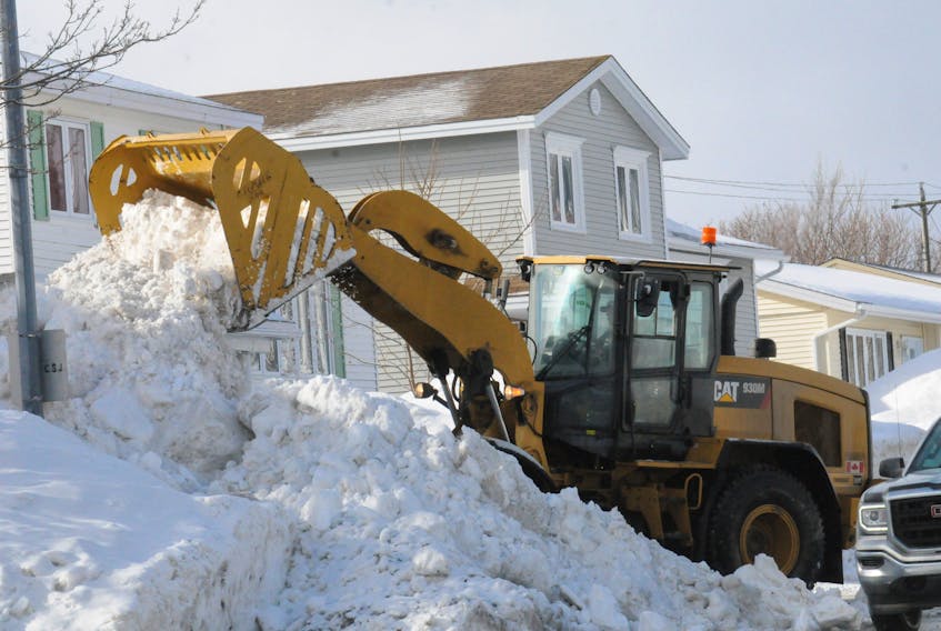 A contractor clears away snow on Newfoundland Drive in east-end St. John’s. — TELEGRAM FILE PHOTO
