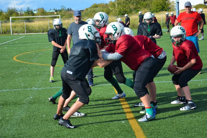 Summerside Spartans head coach Brian Goguen, left, and assistant coach Rob Connell keep a close eye on his players during a practice at Eric Johnston Field earlier this season. The Spartans will meet the Charlottetown Privateers in the Ed Hilton Bowl that will crown the 2019 champion of the P.E.I. Bantam Tackle Football League.