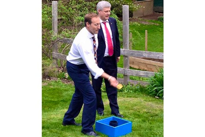 <p>Peter MacKay and Stephen Harper play washer toss in the backyard of MacKay’s New Glasgow home in 2015.</p>