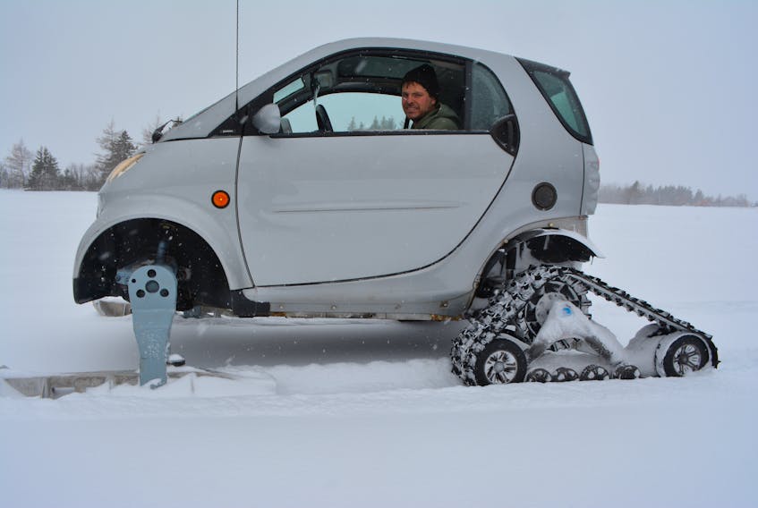 Jarrett Martin shows off the Smart Car he’s converted into a wintertime Smart sled. The sight of the car powering through snow-covered fields has lots of people snapping photos.
Eric McCarthy/Journal Pioneer