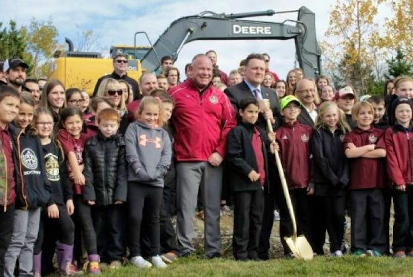 <span>Newbridge Academy CEO Trevor MacEachern (centre left in red jacket) stands beside Mayor Mike Savage (holding shovel) and students during the groundbreaking Thursday.</span>