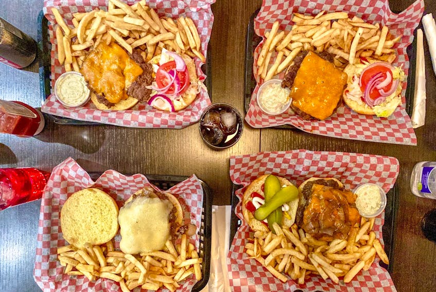 Burgers at The Burger House come open face to showcase all the toppings piled high on fresh brioche buns. 