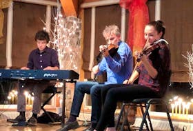 From left, Mark, Brian and Abigail MacDonald, who are son, father and daughter, perform at the Gaelic College’s Wednesday night ceilidh in this file photo.