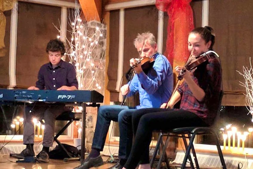 From left, Mark, Brian and Abigail MacDonald, who are son, father and daughter, perform at the Gaelic College’s Wednesday night ceilidh in this file photo.