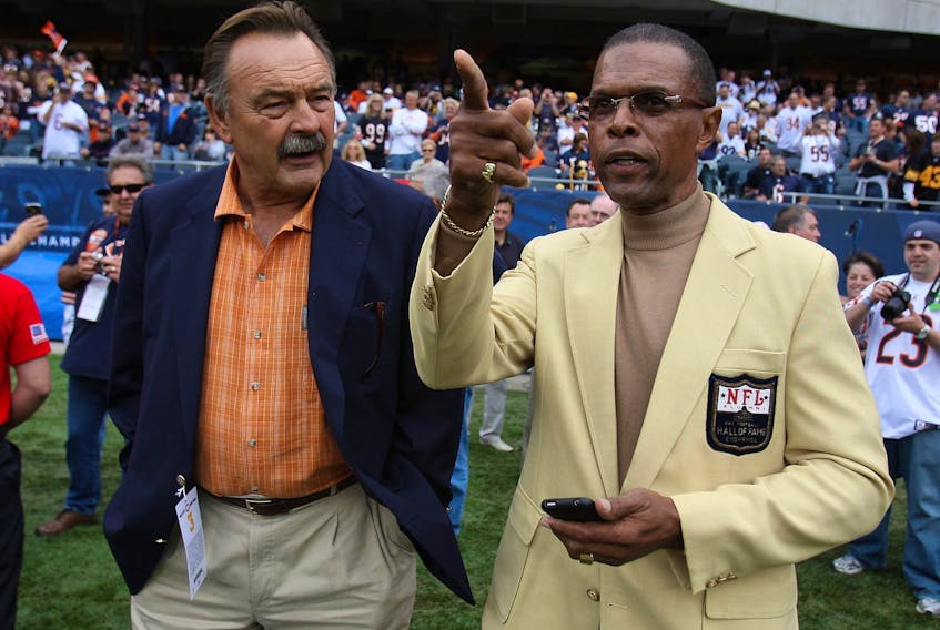 Chicago Bears Hall of Famers Dick Butkus (left) and Gale Sayers chat on the sidelines before a game in 2009. Sayers, who is regarded as one of the greatest running back in NFL history, died following a battle with dementia. He was 77.