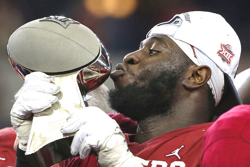 Neville Gallimore of the Oklahoma Sooners kisses the trophy after Oklahoma defeated the Baylor Bears 30-23 in the Big 12 Football Championship at AT&amp;T Stadium on December 7, 2019 in Arlington. (Ron Jenkins/Getty Images)
