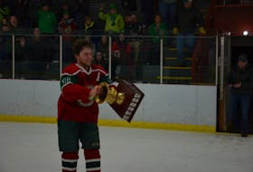 Kensington Monaghan Farms Wild forward and assistant captain Chandler Wood lifts the P.E.I. major midget hockey championship trophy after scoring the winning goal in overtime on Saturday night. The Wild edged the Charlottetown Bulk Carriers Pride 3-2 to win the best-of-seven series in five games.