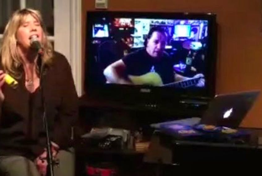 Jenn Sheppard, centre, of New Waterford, performs during a recent "garbage night" live streamed on Facebook with daughter Jordyn Crocker, left, and husband Stephen Muise. Last Thursday the event raised more than $14,000 for iPads for seniors in nursing homes. CONTRIBUTED